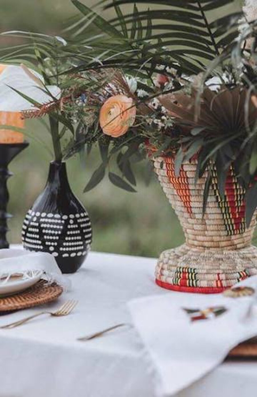 Table detail: patterned vessel, woven basket and palm